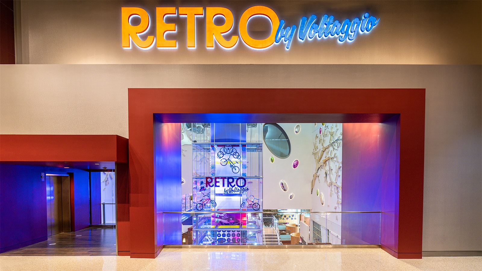 The entrance to Retro by Voltaggio, with a large, bright neon sign above the door